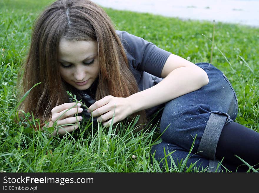 A girl looking at grass. A girl looking at grass