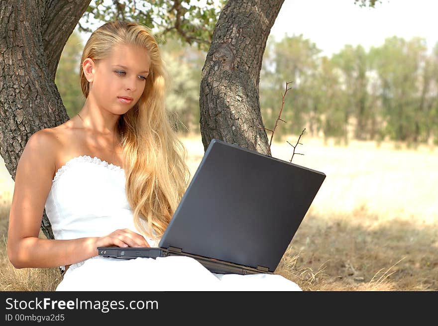 Beautiful girl with a laptop summer