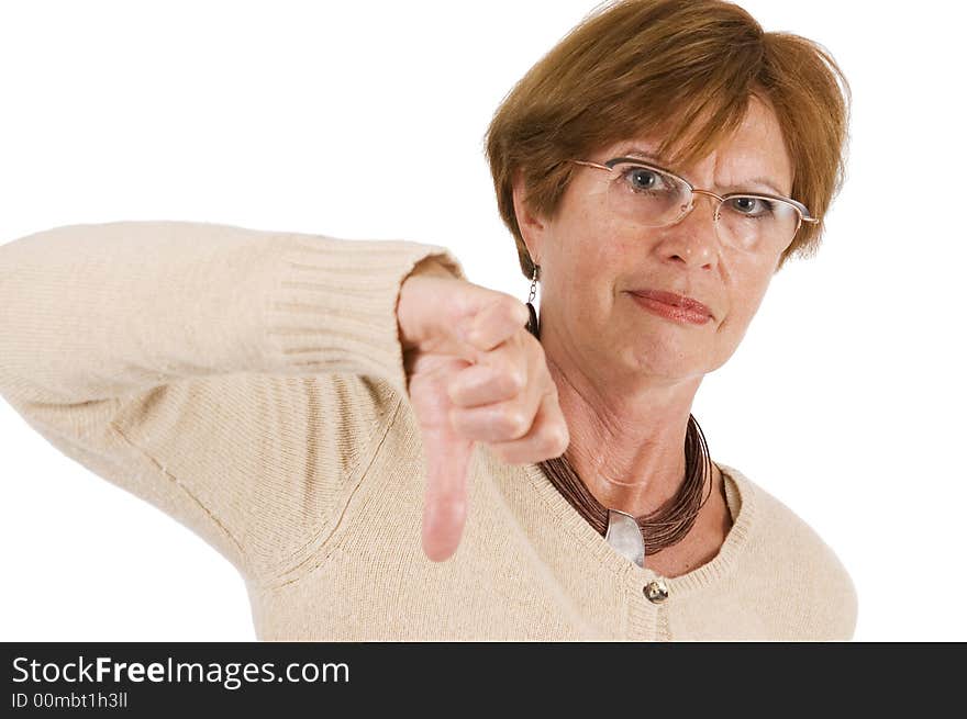 Mature woman holds the thumbs downward with stretched hand; front view. Mature woman holds the thumbs downward with stretched hand; front view