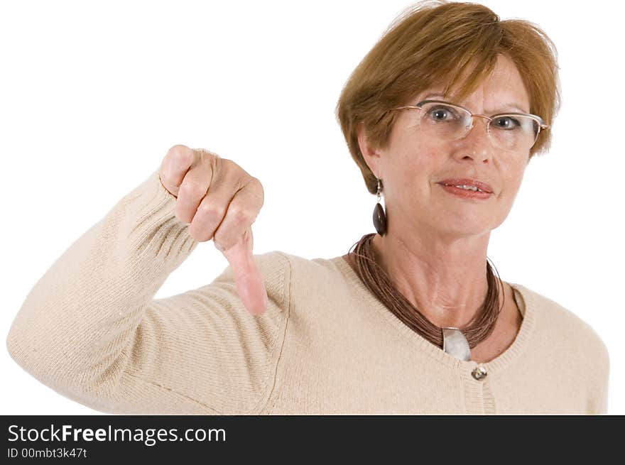 Mature woman holds the thumbs downward with stretched hand; front view. Mature woman holds the thumbs downward with stretched hand; front view