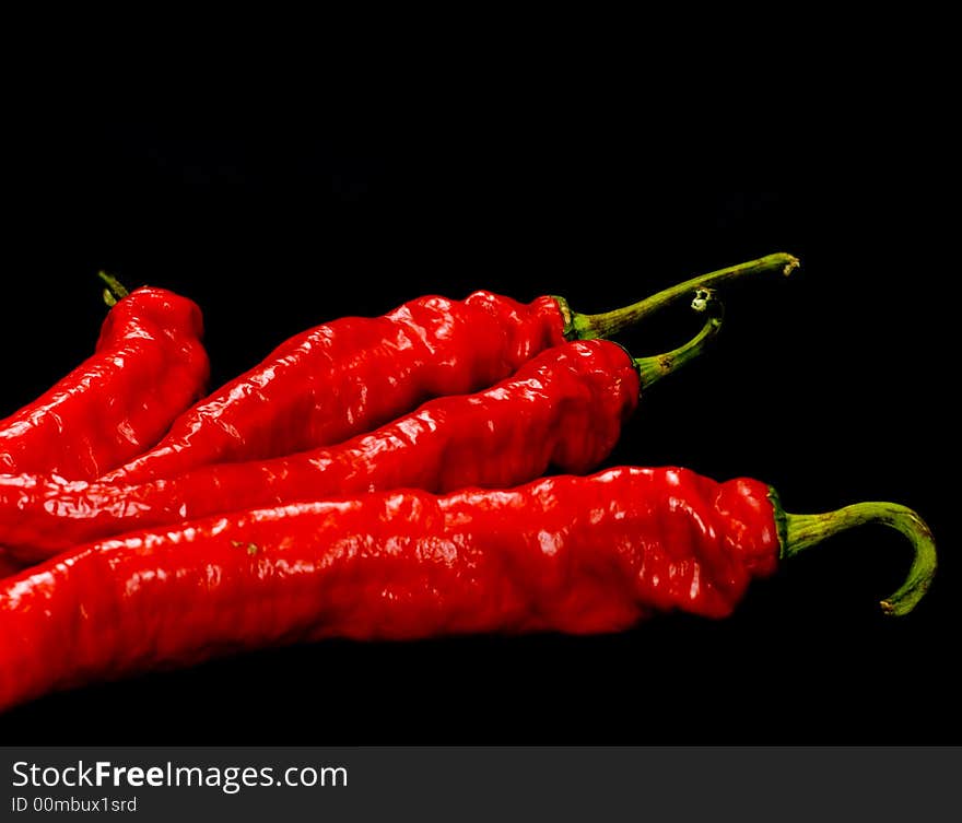 Red Hot chili peppers on black background