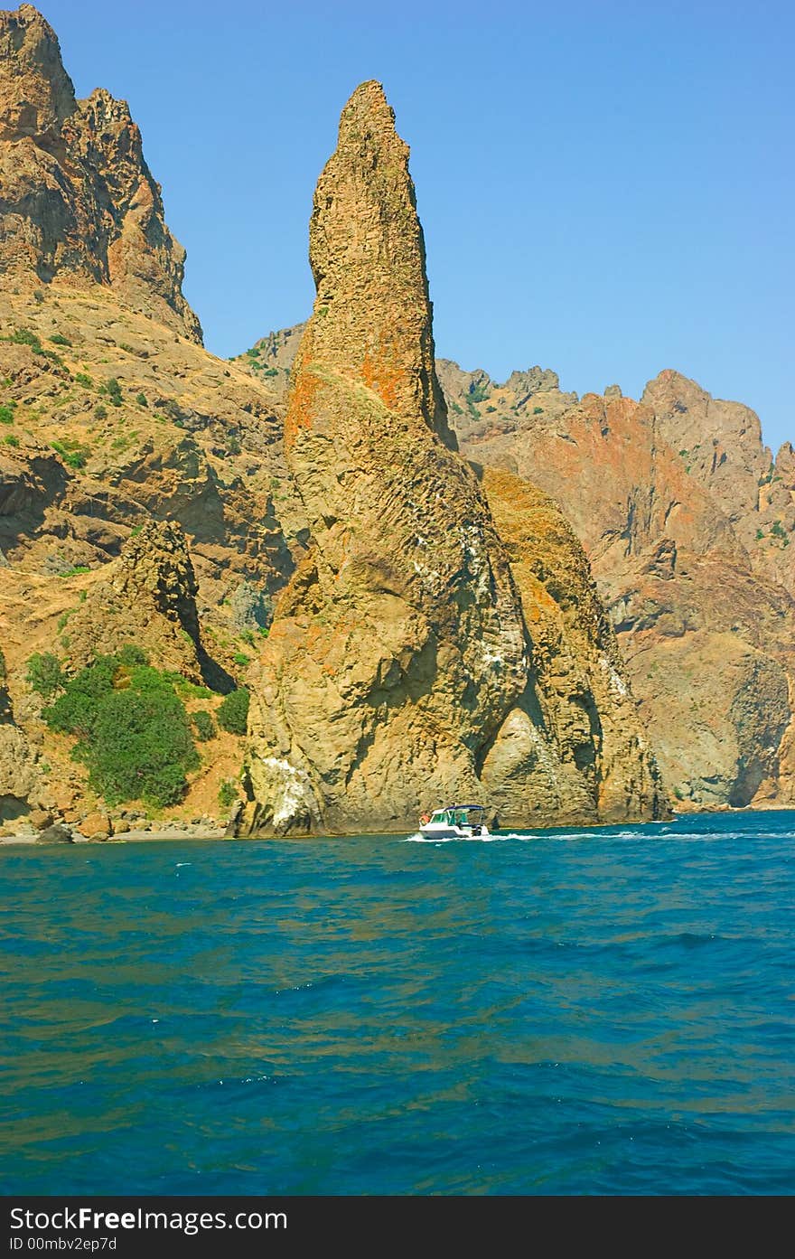 Rocks, boat, blue sea and blu sky. Rocks, boat, blue sea and blu sky