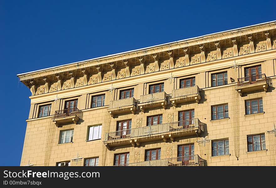 Top of the building. Roofs, balcony, windows and sky