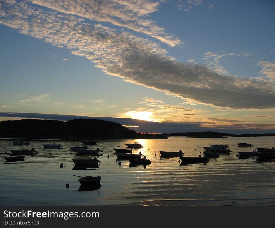 Small boats on a lake during sunset. Small boats on a lake during sunset