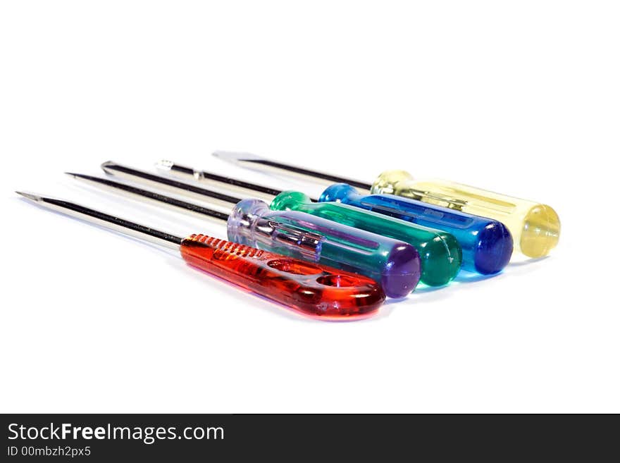 A set of turnscrews with colorful transparent plastic gripes and different points for small works. Shallow depth of field. Focus on gripes. Isolated over white