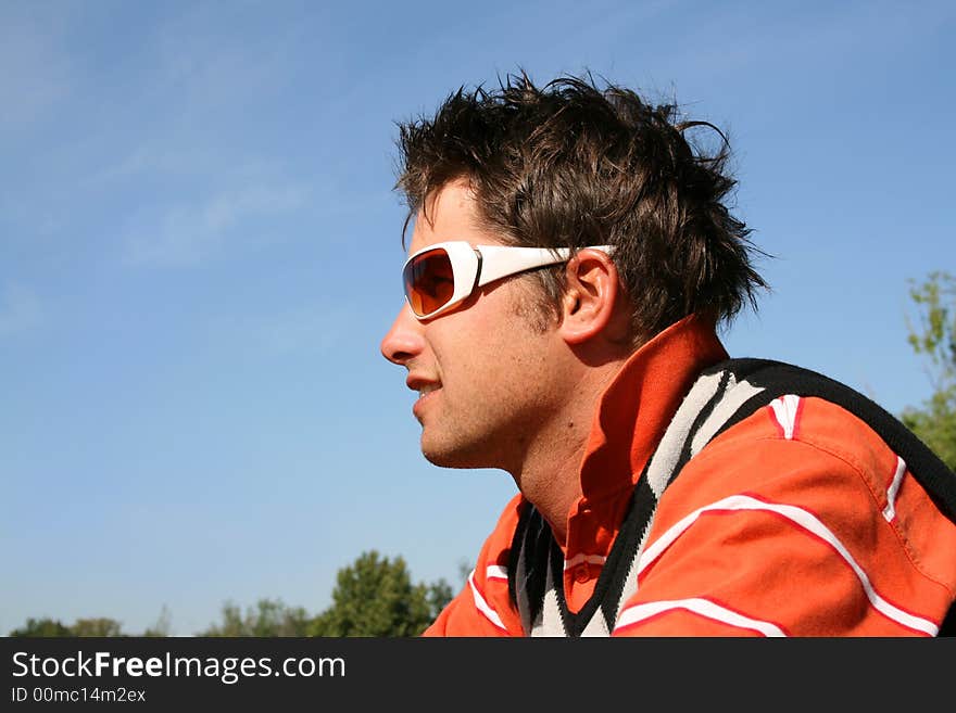 Attractive young model with white frames sunglasses in the park. Attractive young model with white frames sunglasses in the park