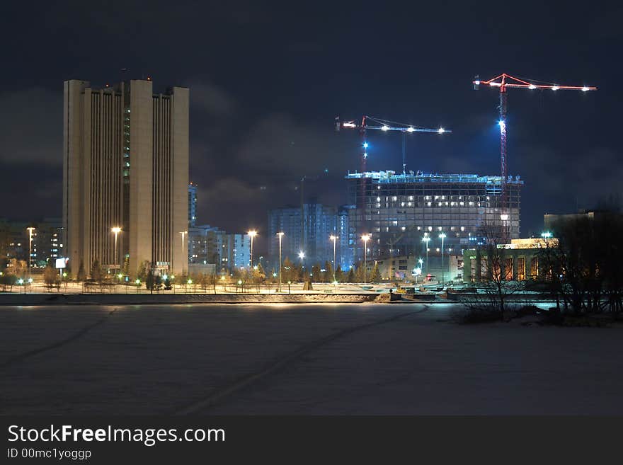 Cranes and lights on night city. Cranes and lights on night city