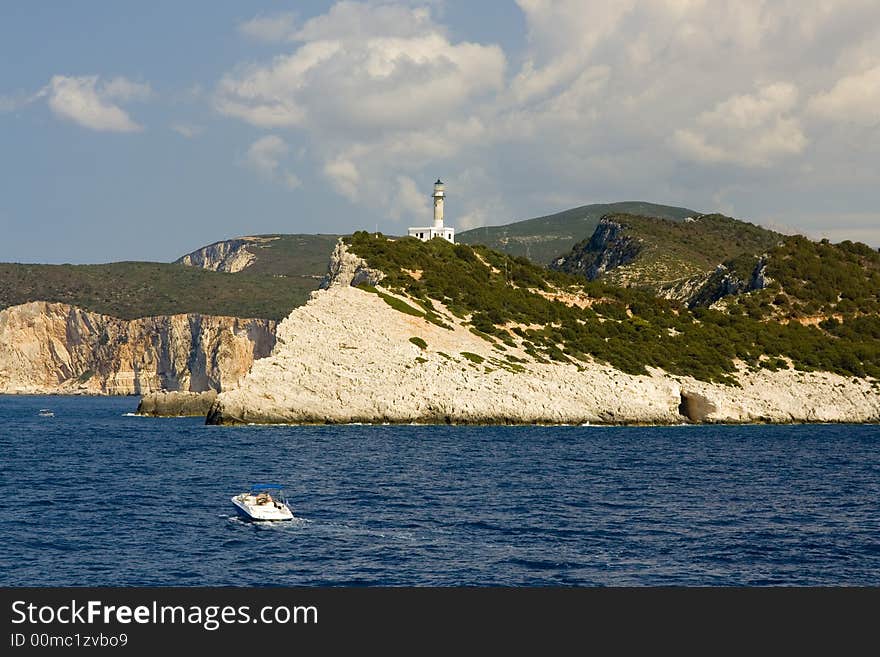 Glittering white rocks on the wild coast of Greek island Lefkada are bathed by water of Ionian Sea. Cape Lefkatas is the southernmost point of the island and it gave the name to whole island.