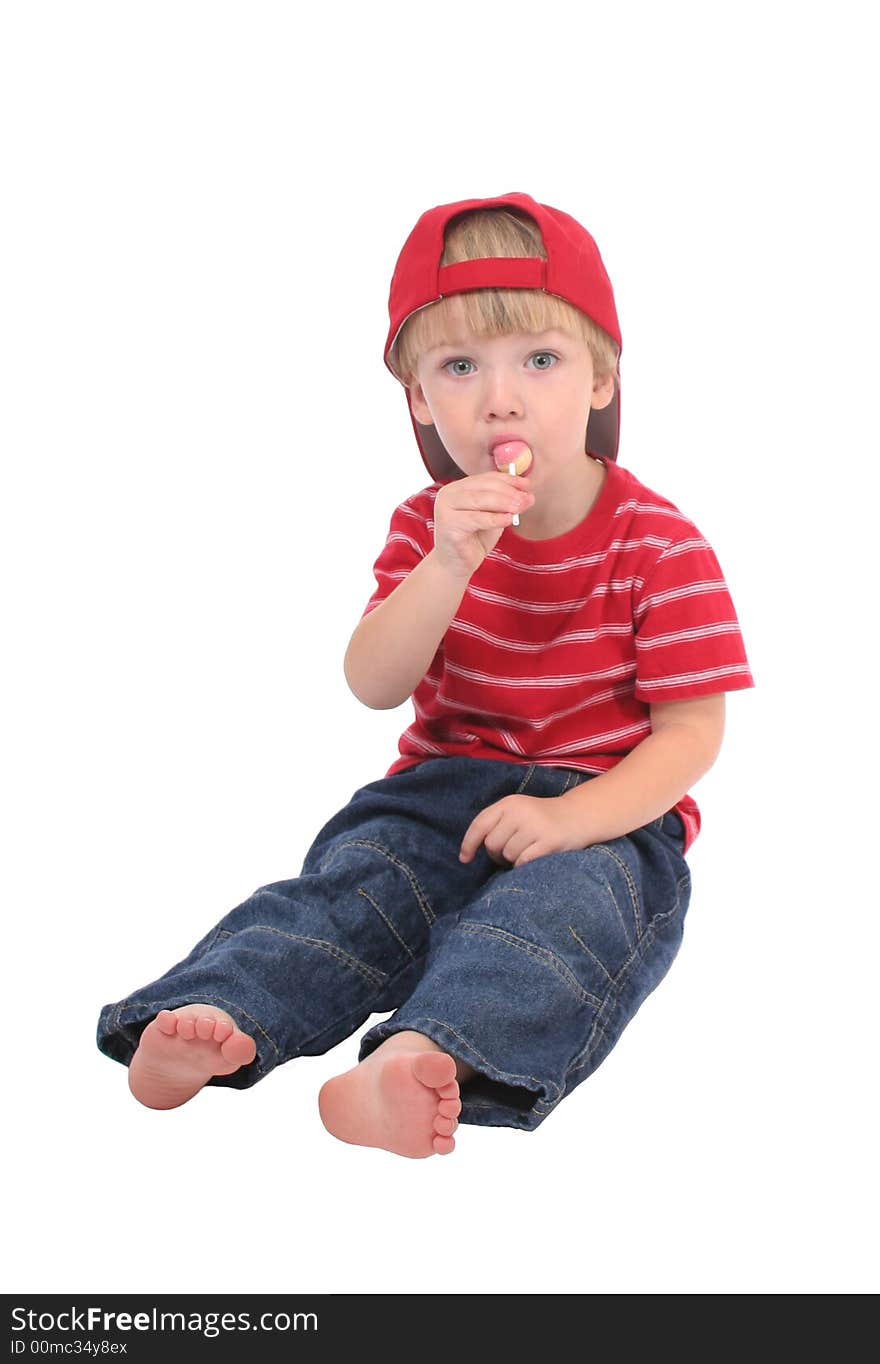 A toddler boy enjoying a lollipop.