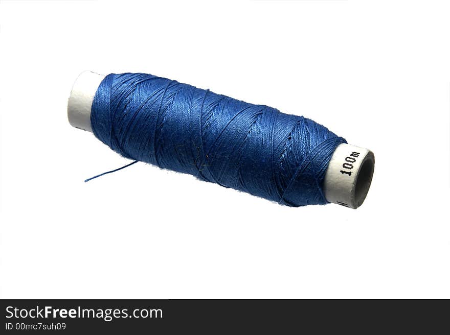 Isolated spool of bluee cotton thread. Isolated spool of bluee cotton thread.