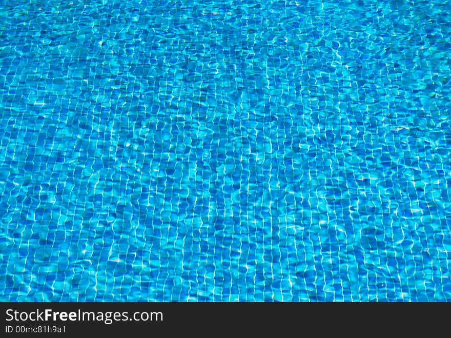 Water rippling in a pool. Bright blue water background. Water rippling in a pool. Bright blue water background.