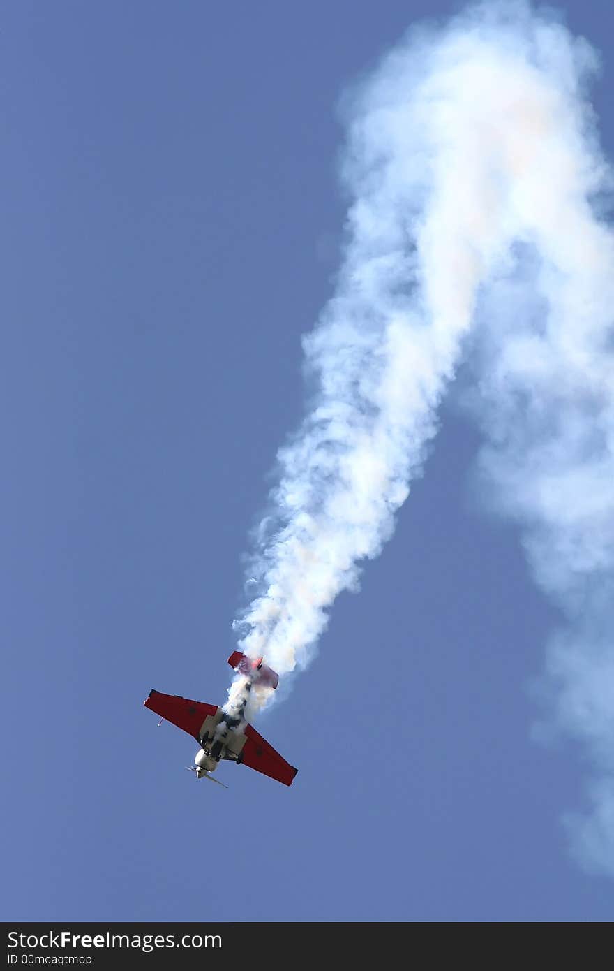 An acrobatic pilot showing his mastership at the Aviation Fest in Siauliai (Lithuania). An acrobatic pilot showing his mastership at the Aviation Fest in Siauliai (Lithuania).