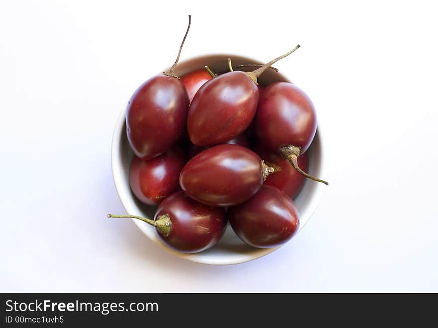 A bowl of juicy ripe red tamarillo fruit. A bowl of juicy ripe red tamarillo fruit