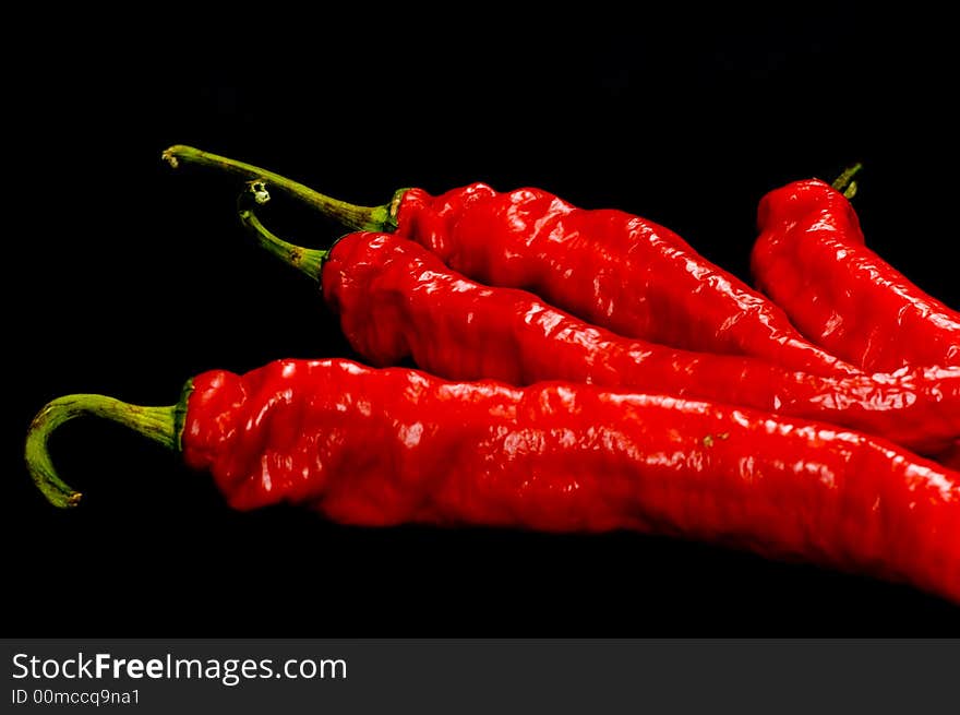 Red Hot chili peppers on black background