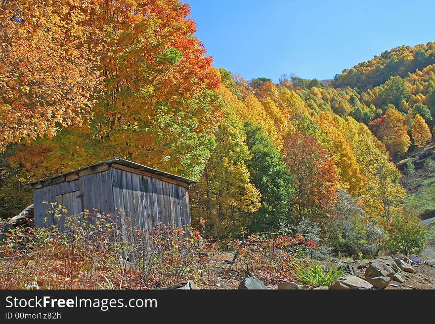 Colorful autumn mountain scene with rustic out building. Colorful autumn mountain scene with rustic out building