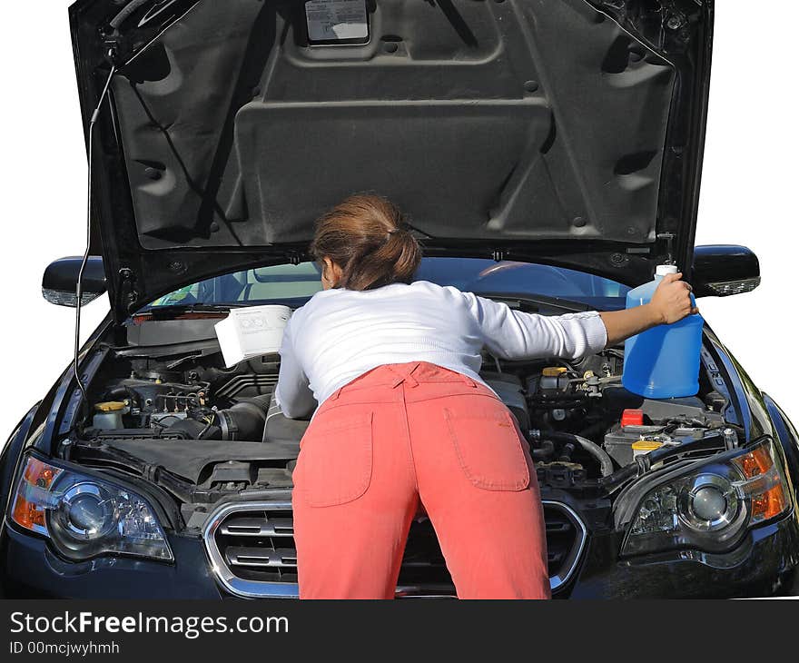 Attractive woman in red jeans trying to fix the car with a manual book. Attractive woman in red jeans trying to fix the car with a manual book