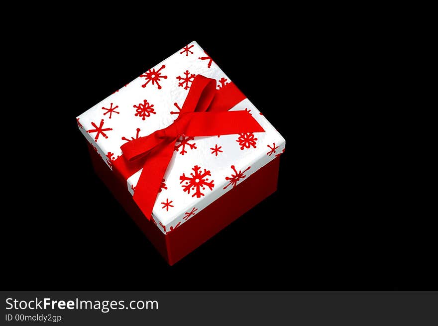 Red and white gift box on black background with copy space