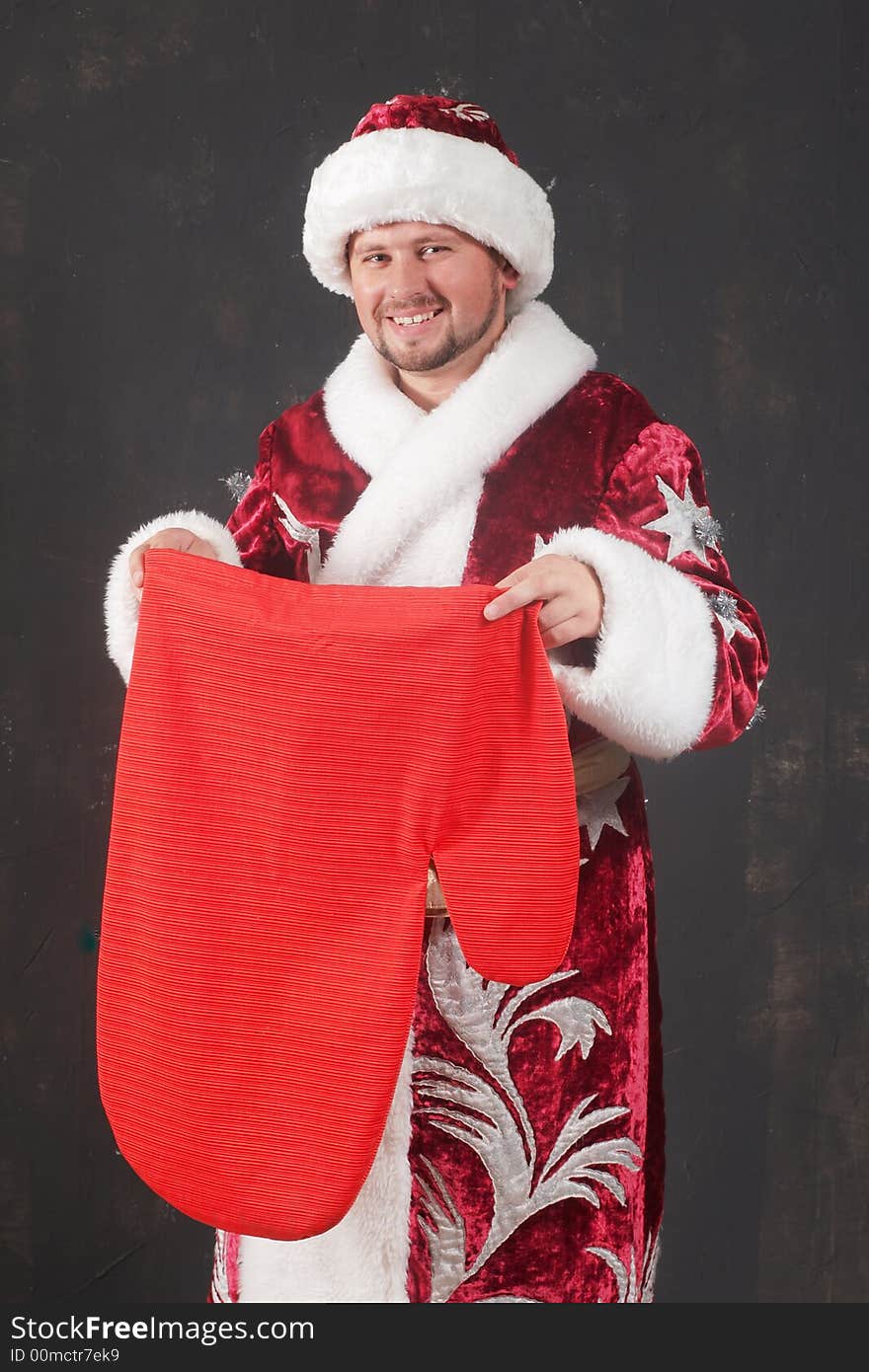 An image of smiling Santa with red bag