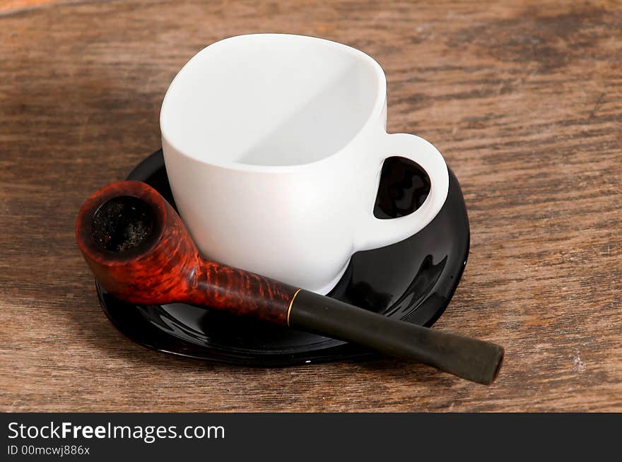 Pipe and white cup