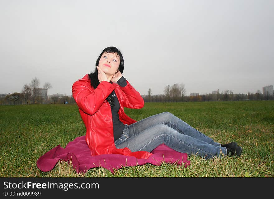 Woman is sitting on a Plaid