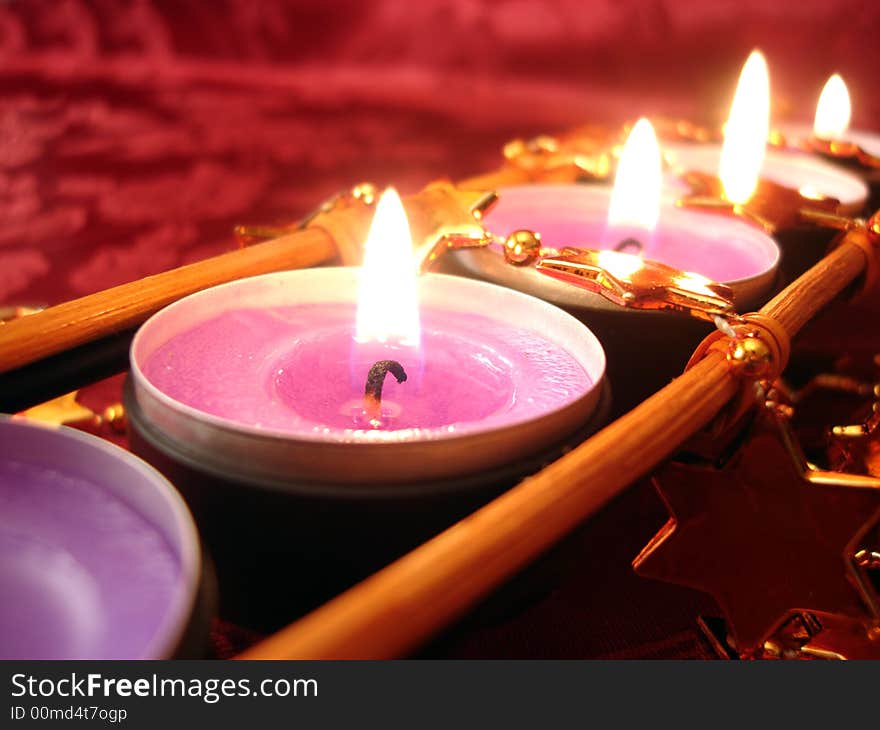 Row of pink candles with stars, close-up