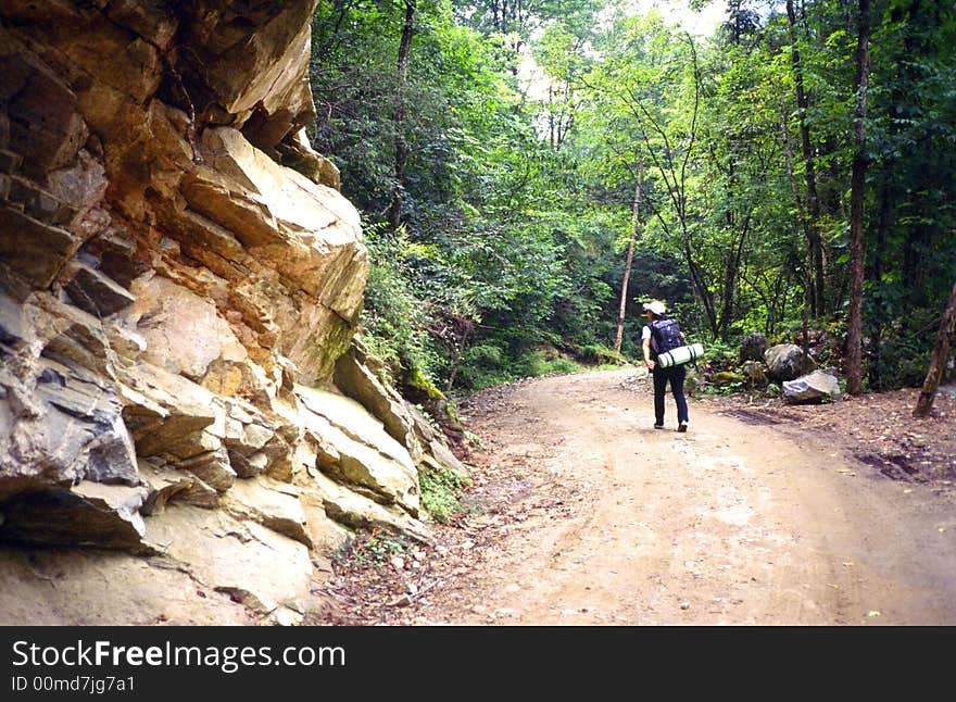 A hiker on the road of mountain.Shaanxi province,China.