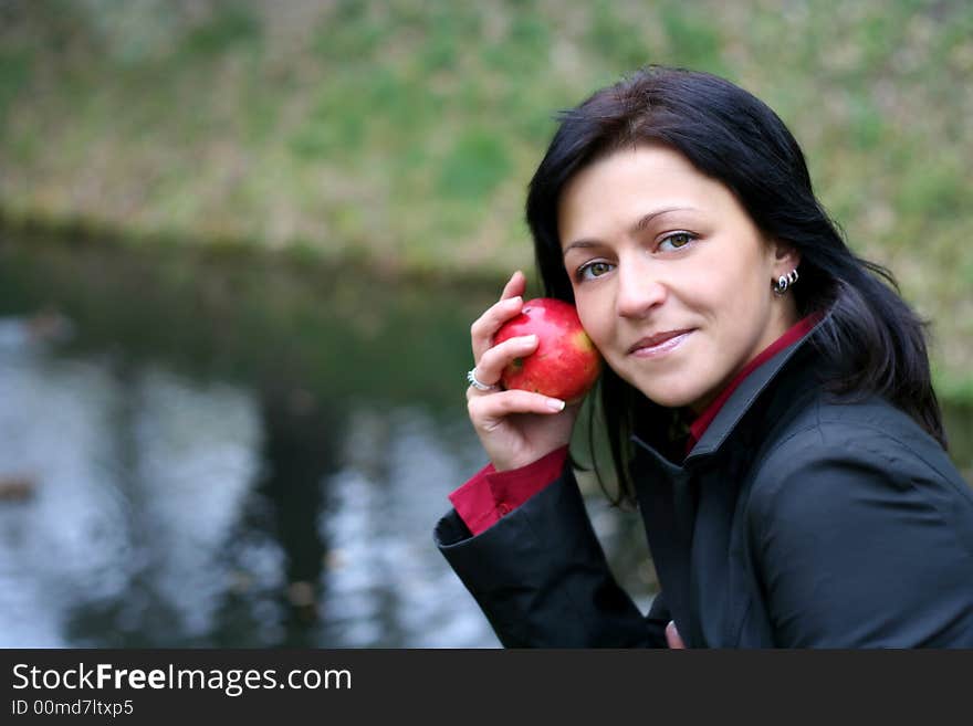 Woman And Apple In Autumn Park