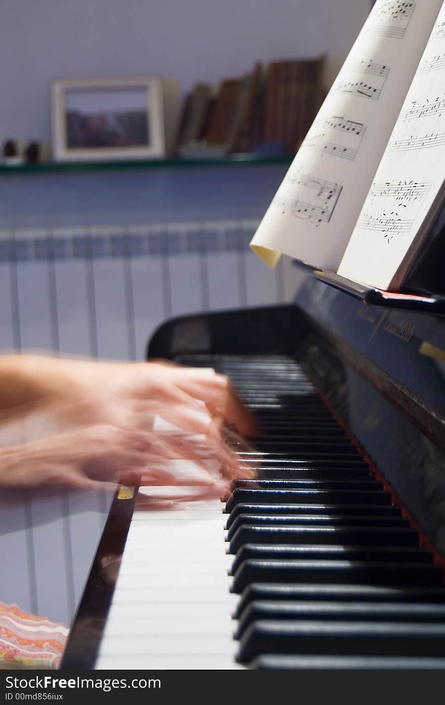 Hands playing Bach on piano