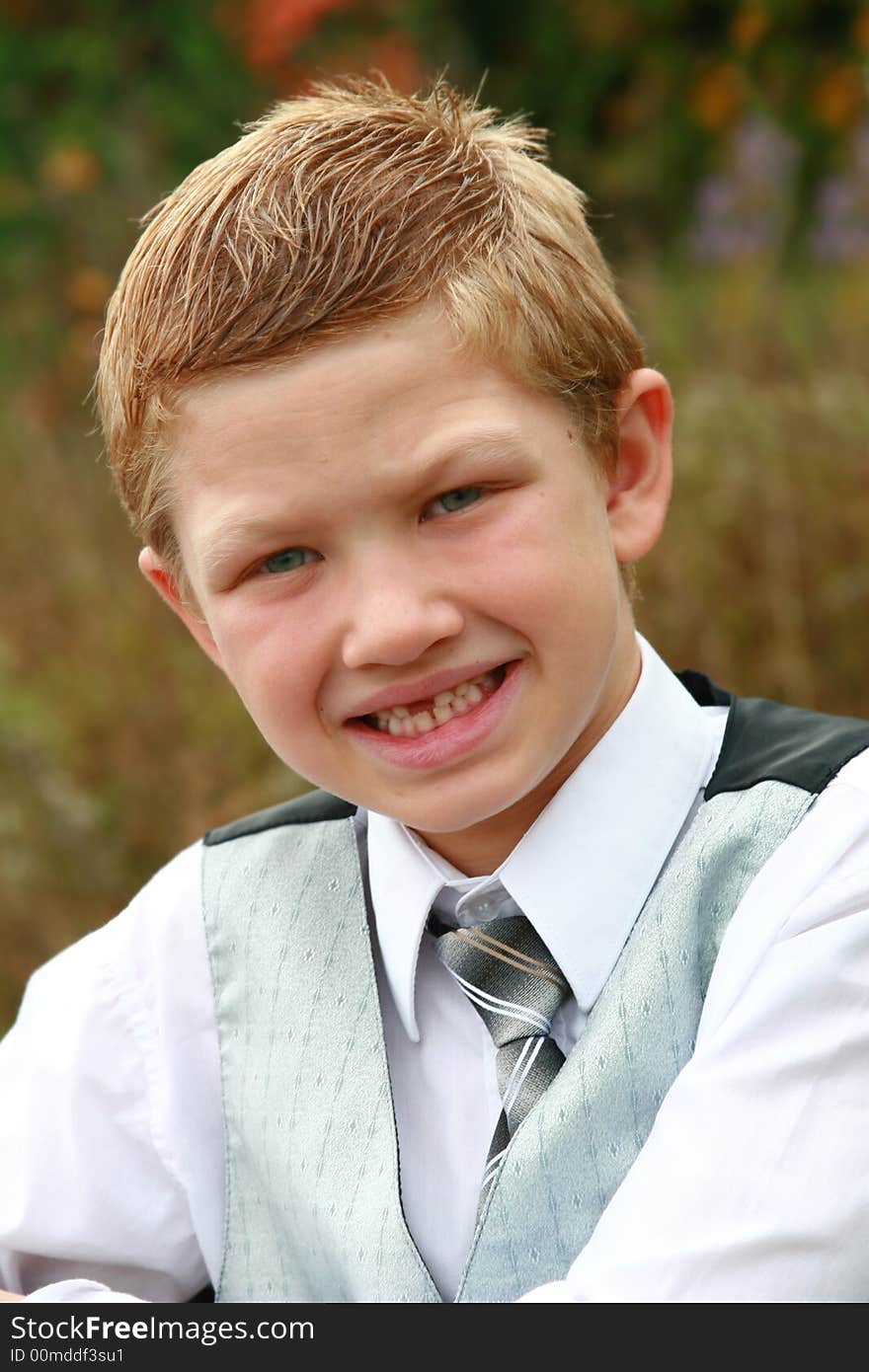 Cute smiling little boy posing for a portrait. Cute smiling little boy posing for a portrait.