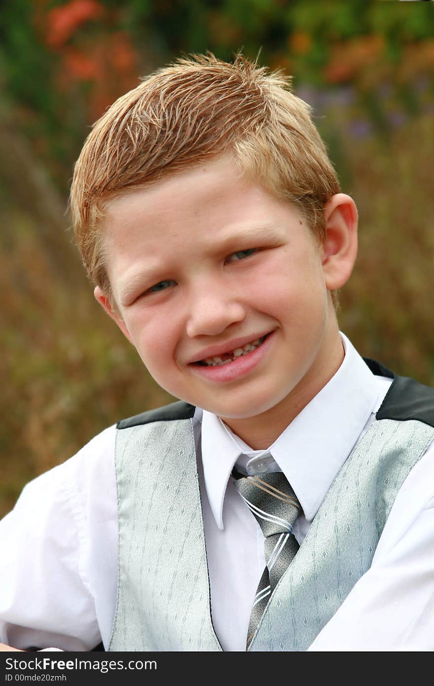 Adorable young boy posing for a picture. Adorable young boy posing for a picture.