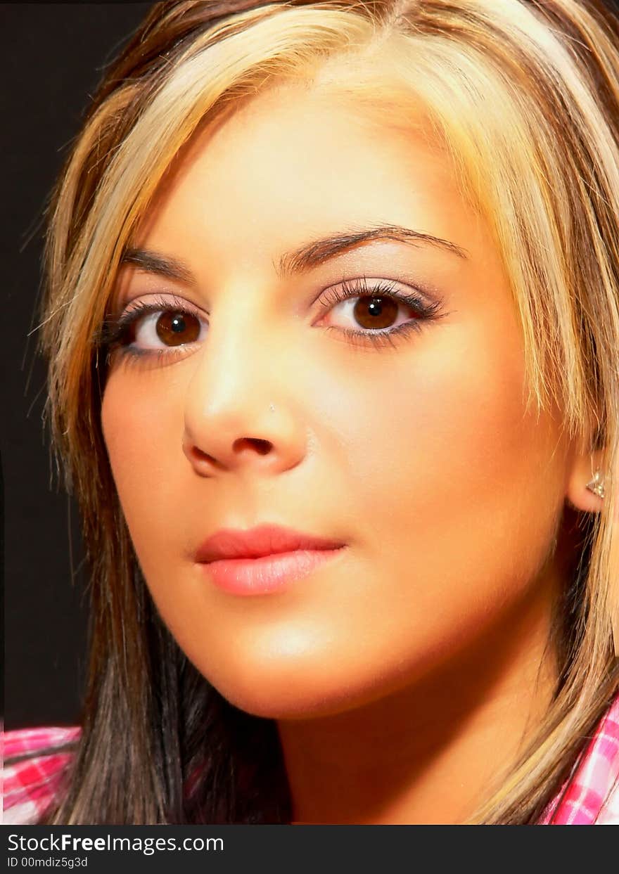 An portrait of a beautiful young blond lady wearing a pink top in front
of an black background. An portrait of a beautiful young blond lady wearing a pink top in front
of an black background.