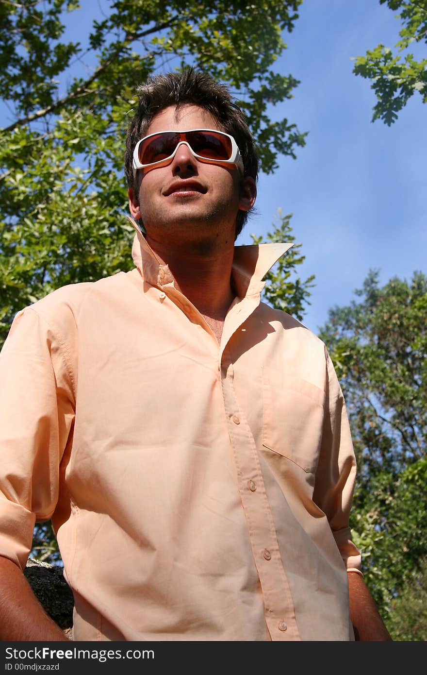 Attractive young model with white frames sunglasses in the park. Attractive young model with white frames sunglasses in the park