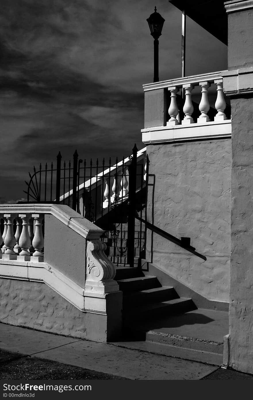 The back portion of an aging condominium building against a black and white sky. The back portion of an aging condominium building against a black and white sky