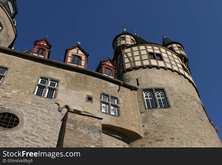 Strong and solid walls of an old german medieval castle with a deep blue sky in the background. Strong and solid walls of an old german medieval castle with a deep blue sky in the background