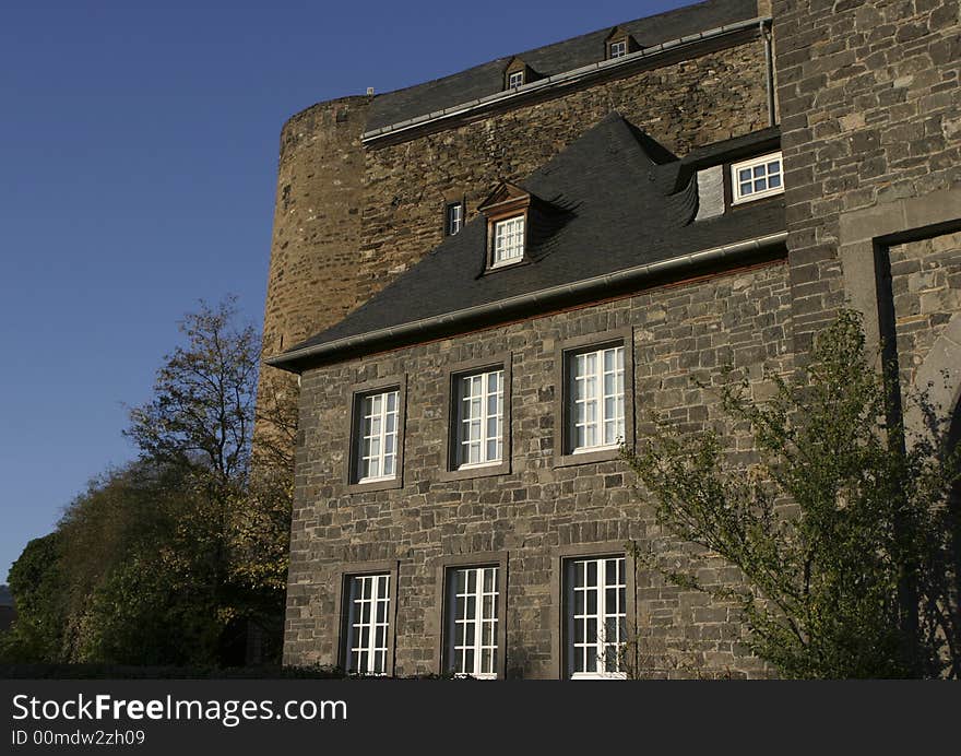 Strong and solid walls of an old german medievyl castle with a deep blue sky in the background. Strong and solid walls of an old german medievyl castle with a deep blue sky in the background