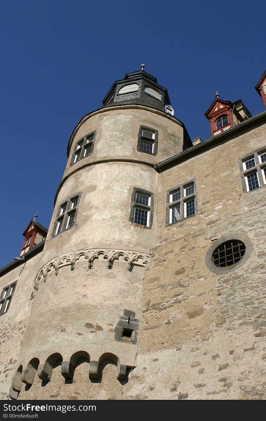 Tower of a medieval castle in Germany standing in the bright sunlight of a clear autumn day. Tower of a medieval castle in Germany standing in the bright sunlight of a clear autumn day