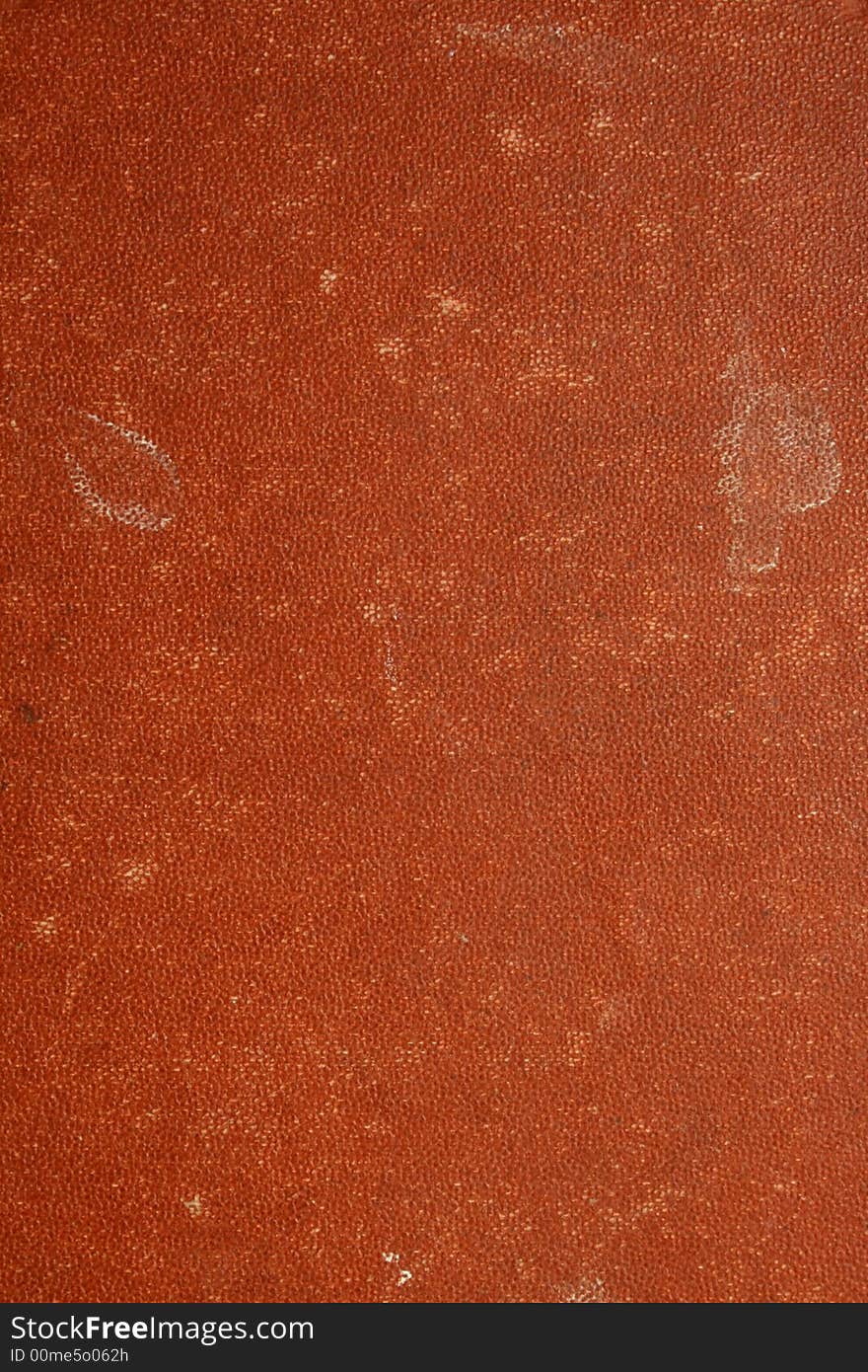 Close up of a red document with a weathered, old look. Close up of a red document with a weathered, old look