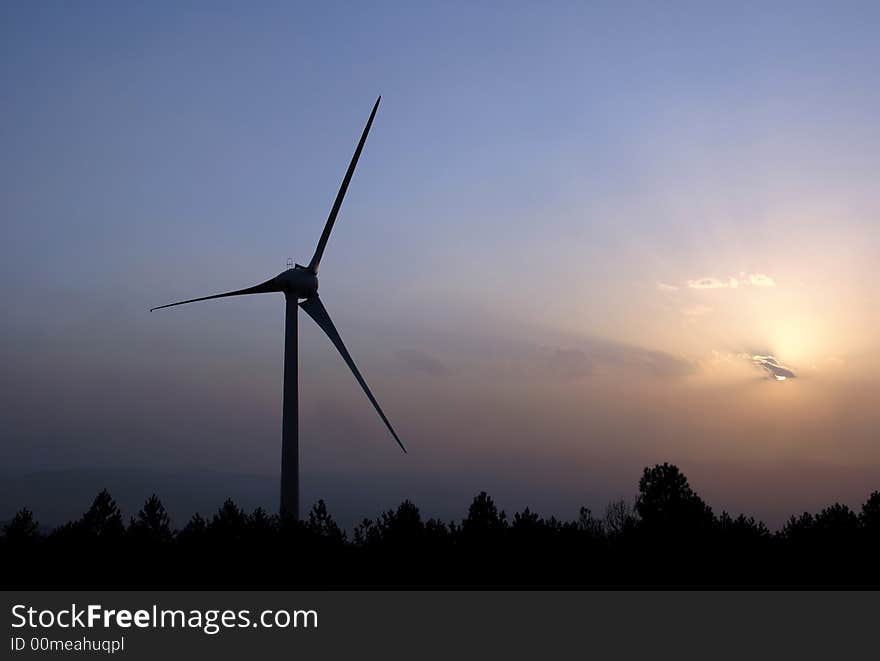 Wind turbine farm at sunset, silhouette