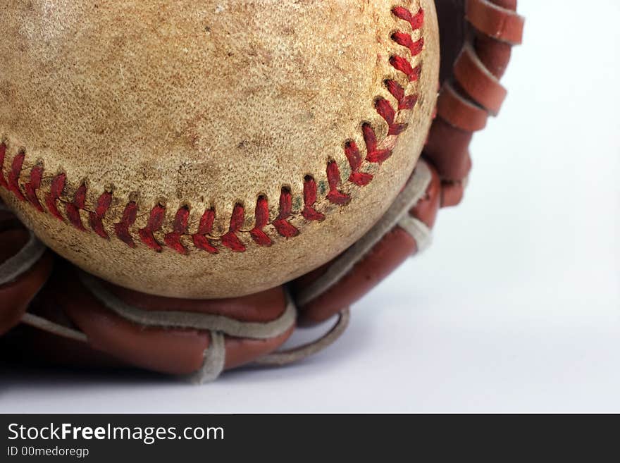 Baseball with red stitching and outfielders glove (mitt) on a white background,sports