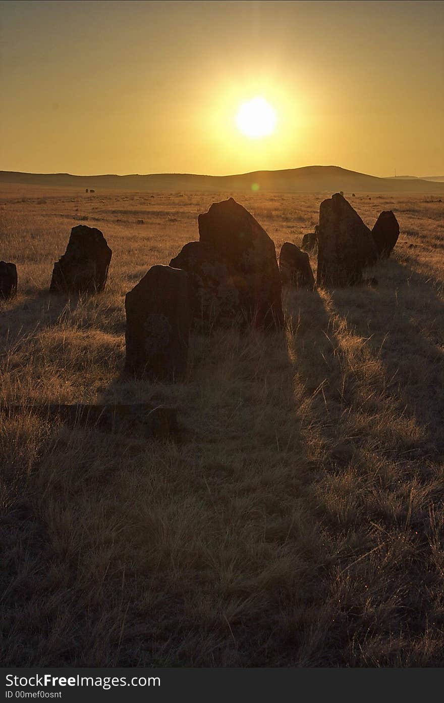 Sunrise in Khakasia trow the stones