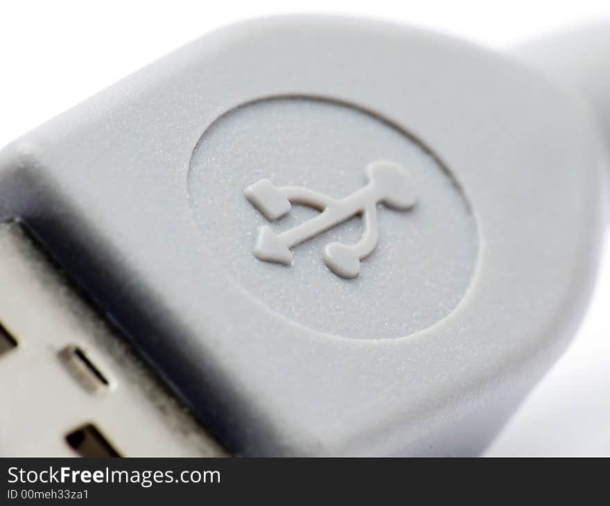 Extreme macroshot of an USB connector clearly showing the USB symbol