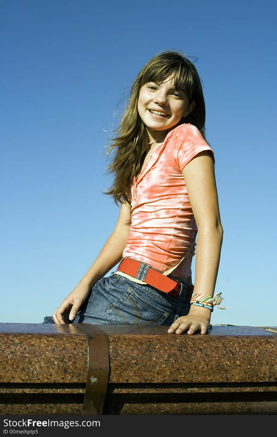 A portrait of a smiling girl on a background of the sky. A portrait of a smiling girl on a background of the sky