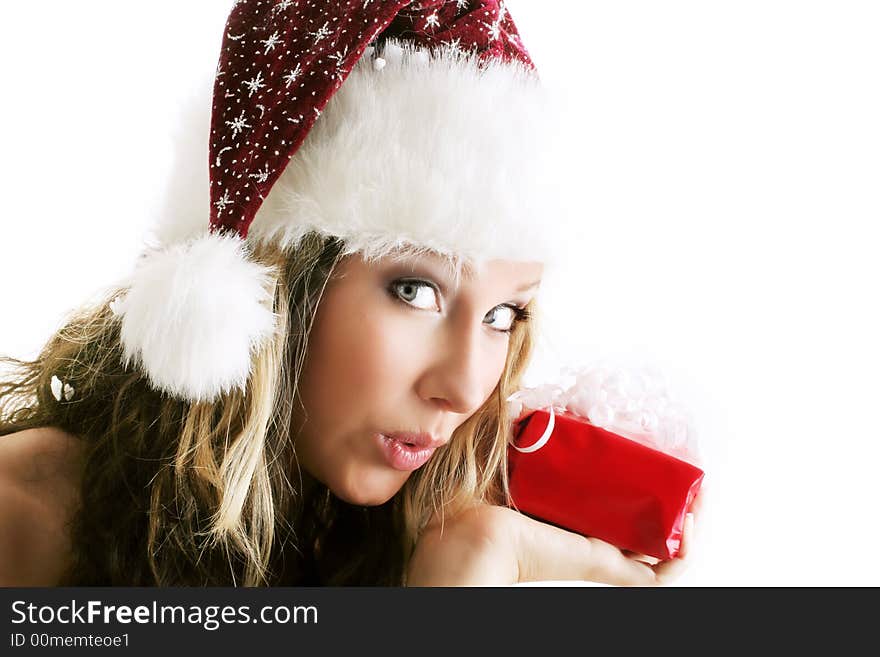 Winter portrait of a beautiful young woman with a cap and a scarf and a gift in her hands. Winter portrait of a beautiful young woman with a cap and a scarf and a gift in her hands