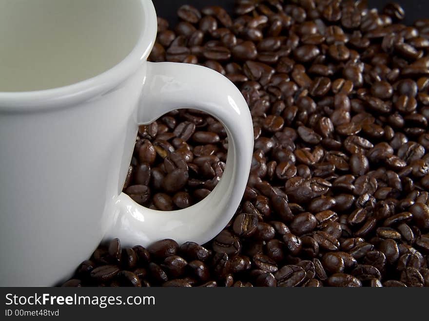 Coffee beans and white coffee cup. Coffee beans and white coffee cup