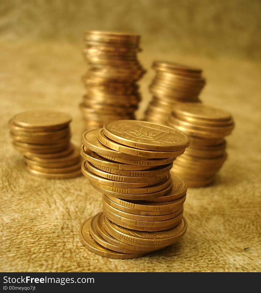 Stack of golden coins on yellow background