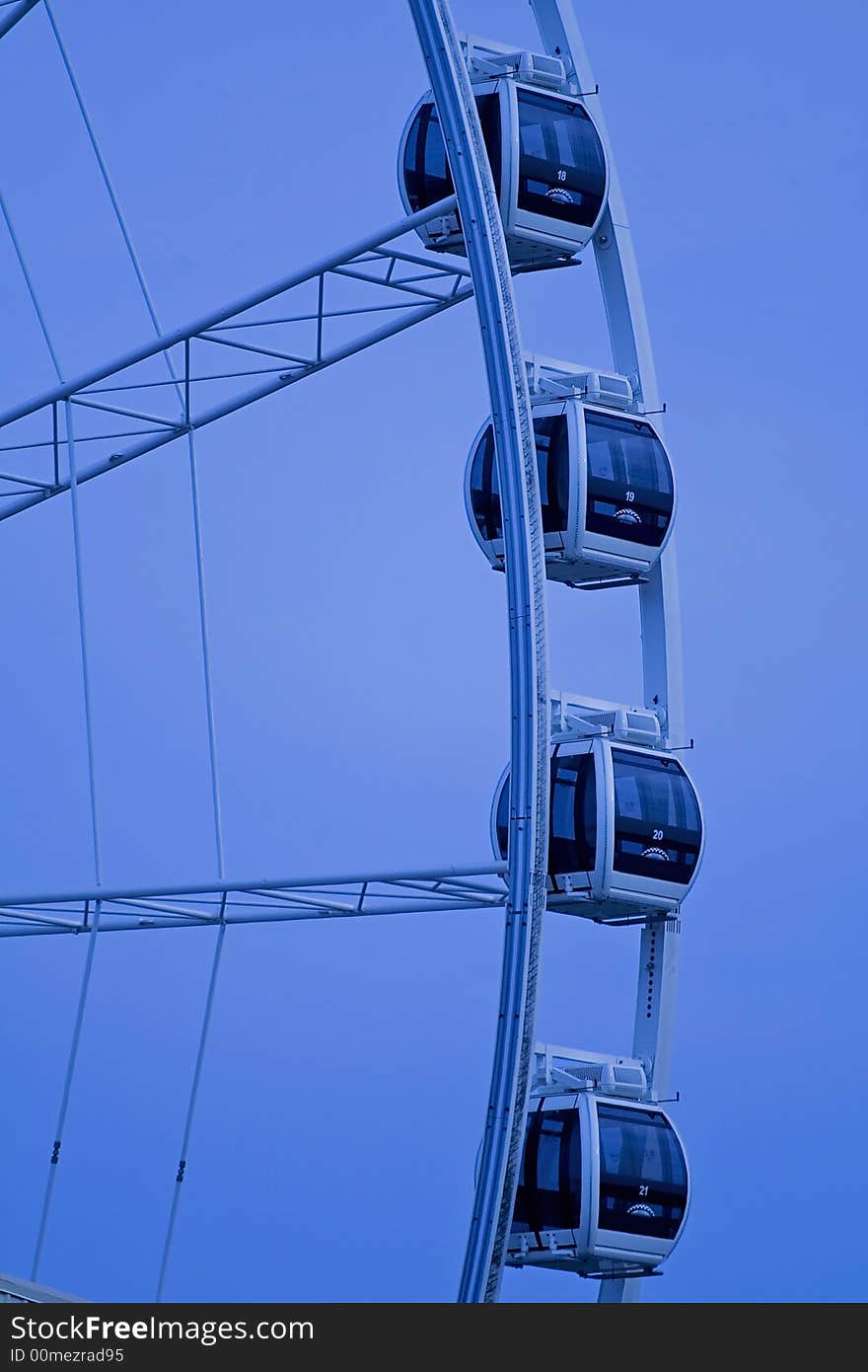 Ferris wheel against blue background