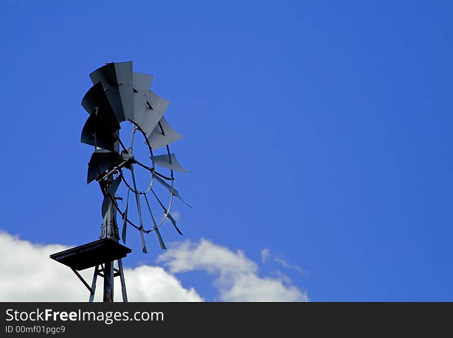 Farm wind mill blue sky & clouds