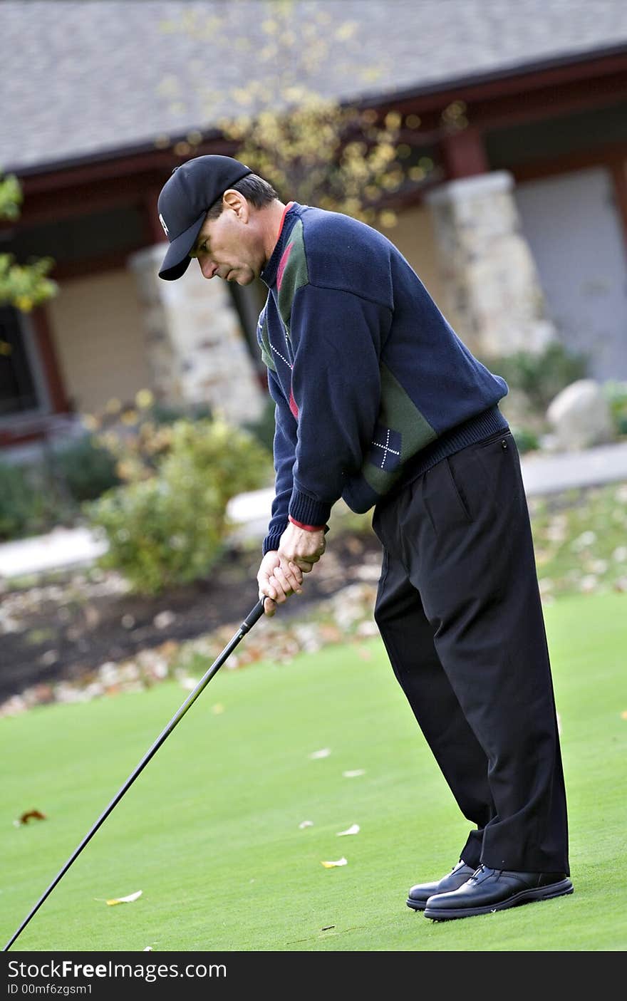 A male golfer plays a game on a beautiful fall day. A male golfer plays a game on a beautiful fall day.