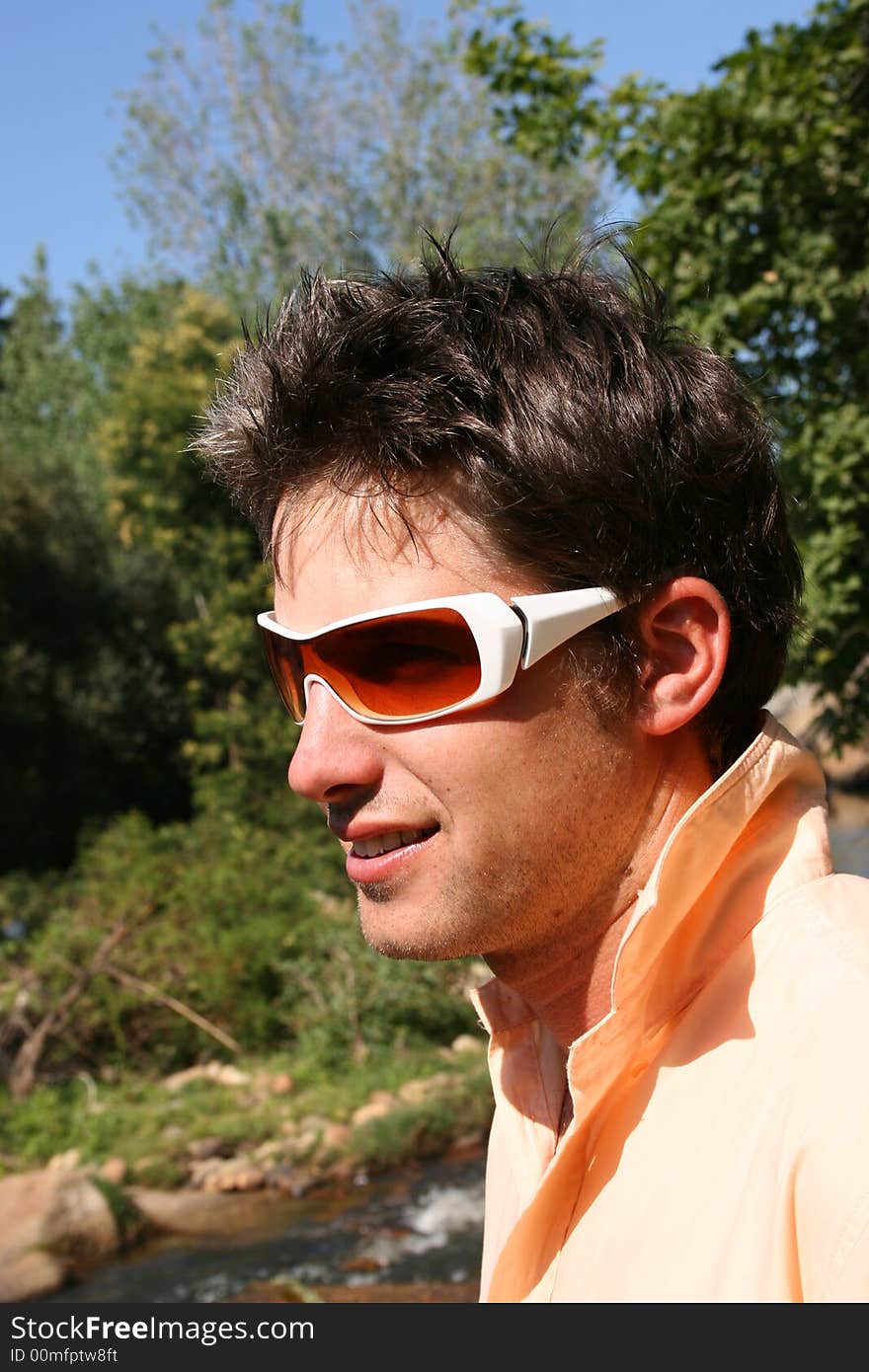 Close up of a young model, half profile with white sunglasses. Close up of a young model, half profile with white sunglasses