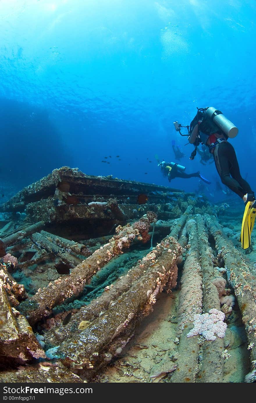 Underwaterphotographer on a ships wreck with other diver in background. Underwaterphotographer on a ships wreck with other diver in background